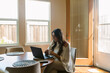 © ByLorena/Stocksy - Beautiful woman working in computer from home during morning