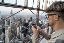Guy Is Admiring Manhattan's Panorama From High Viewpoint