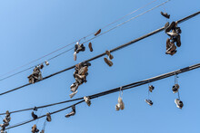 Closeup View At Hanging Sneakers And Shoes