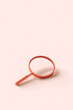 © Giada Canu/Stocksy - a pink magnifying glass with copyspace