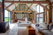 © Paul Phillips/Stocksy - Large living area in a converted barn.