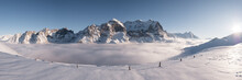 Snowy Alpine Landscape And Sea Of Fog Panorama.