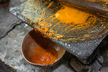 Close Up Of Red Chili Sauce Ground On A Stone Metate In Oaxaca 
