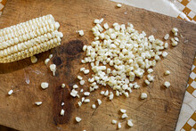 Corn White Kernels And Elote On A Wooden Chopping Board