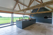 © Paul Phillips/Stocksy - A modern kitchen island in the centre of the room. Converted barn.