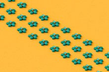 Rows Of Blue Abstract Flowers On A Yellow Background
