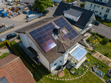 Fototapeta Na sufit - Aerial drone view of solar/photovoltaic panels on a houses roof top, Frankfurt Germany Spring