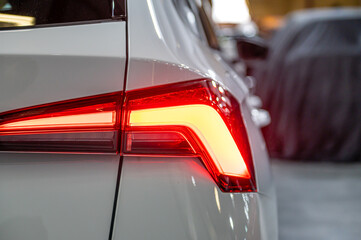 Wall Mural - closeup of a red led taillight on a modern car, detail on the rear light of a car