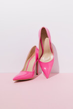 Two Pink High Heels Against Pastel Backgorund.