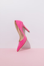 Pink High Heel Against A Pastel Wall.