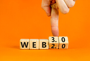 WEB 2.0 or 3.0 symbol. Businessman turns wooden cubes and changes concept words WEB 2.0 to WEB 3.0. Beautiful orange table orange background copy space. Business technology and WEB 2.0 or 3.0 concept.