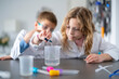 © Albert Martinez/Stocksy - Children mixing chemical substances during lesson