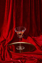 Wine Glass On The Glamour Luxurious Red Velvet Curtain