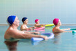 © Santi Nuñez/Stocksy - Senior people exercising in pool