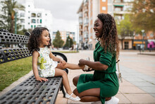 Young Black Woman With Her Daughter In The City Park