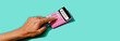© Juan Moyano/Stocksy - using a pink calculator in web banner format
