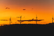 © Leonardo Borges/Stocksy - Sunset with wind towers rotating and generating energy.