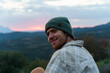 © Alba Vitta/Stocksy - Portrait of happy man in nature at sunset looking at camera