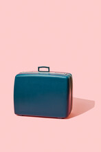 Retro Suitcase Standing On A Pink Background