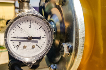 Close-up of a pressure gauge for measuring installed in water or gas supply systems. Plumbing equipment