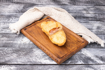 Wall Mural - Meat pies, on a white wooden background, wooden plate