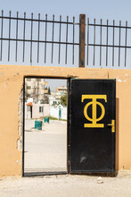 Gate To A Parking Lot With Religios Symbol