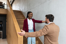 Young Business People Met On The Staircases In The Office Building Woman Congratulates Man Colleague On Job Promotion. Successful Happy Workers Talking Not Seeing Long Tame When She Is Promoted.