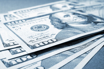 Wall Mural - american paper money. several one hundred dollar notes lie on textured surface. focus on the number 