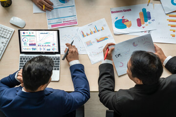 Business data dashboard analysis by ingenious computer software . Investment application display business sales and profit on the computer screen and advise marketing planning decision .