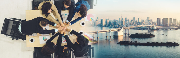 Wall Mural - Happy business people celebrate teamwork success together with joy at office table shot from top view . Young businessman and businesswoman workers express cheerful victory in broaden view .