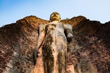 Wall Mural - Ancient Standing Buddha Statue in historical park