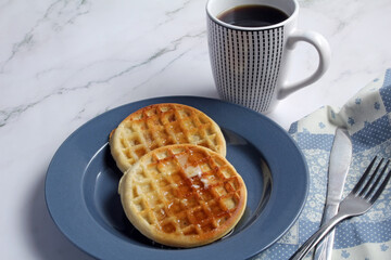 Wall Mural - Waffles with butter and syrup, and coffee for breakfast.