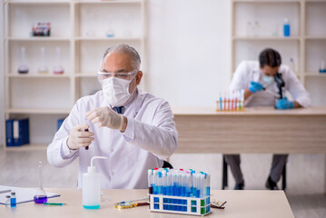 Two male chemist working at the lab