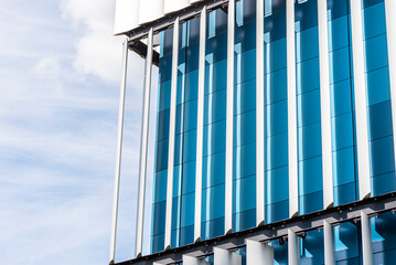 The facade of a modern building with an innovative facade made of automatic, movable blinds.