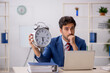 © Elnur - Young male employee in time management concept