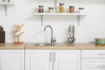 Canvas Print - Interior of light kitchen with white counters and utensils