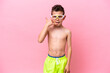 © luismolinero - Little caucasian boy wearing a diving goggles isolated on pink background making phone gesture. Call me back sign