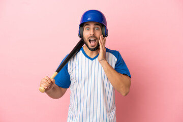 Wall Mural - Baseball player with helmet and bat isolated on pink background with surprise and shocked facial expression