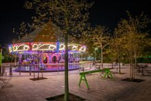 Merry Go Round At Night Shining On The Leaves