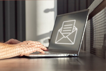 Poster - Spam email. Man receiving junk mail, unwanted messages, ads for money scams while working on laptop. Hands on keyboard closeup. High quality photo