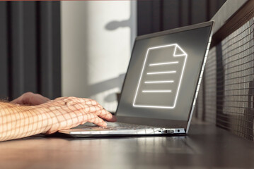 Poster - Man working on laptop with electronic document, creating, sharing online. Paperless workplace concept. Hands on keyboard closeup. High quality photo