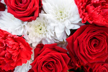 Close-up Red And White Bouquet Of Solemn Festive Flowers Of Fresh Bright Carnations, Roses With Asters Heads. Concept Of Funeral And Memorial Event. Gift Card, Copy Space, Floral Plant Background.