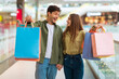 © Prostock-studio - Excited Couple Showing Colorful Shopper Bags Shopping In Mall