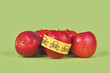 Apples with poison skull symbol sticker on green background. Concept of pesticide residues in agricultural food