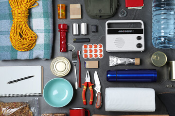 Disaster supply kit for earthquake on dark grey table