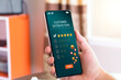 © AKACHA - Customer satisfaction assessment concept. customer show smartphone screen send satisfaction rate five stars, send smiley emoji and hearts, satisfied smiley face, excellent service, customer be happy.