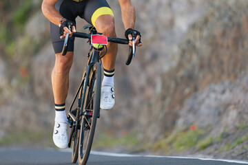 Poster - Male cyclist riding racing bicycle, man cycling on countryside summer road. Training for triathlon or cycling competition