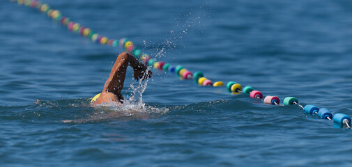 Wall Mural - Swim competition swimmer athlete doing crawl stroke in sea swimming