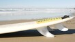 Surfboard for surfing lying on beach sand, California coast, USA. Ocean waves and white surf board or paddleboard. Longboard or sup for watersport by sea water. Summer vacations, sport on shore vibes.
