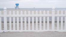 Lifeguard Stand Or Life Guard Tower Hut, Surfing Safety On California Beach, USA. Rescue Station, Coast Lifesavers Wachtower Or House, Coronado Ocean Beach, San Diego Shore. White Wooden Picket Fence.